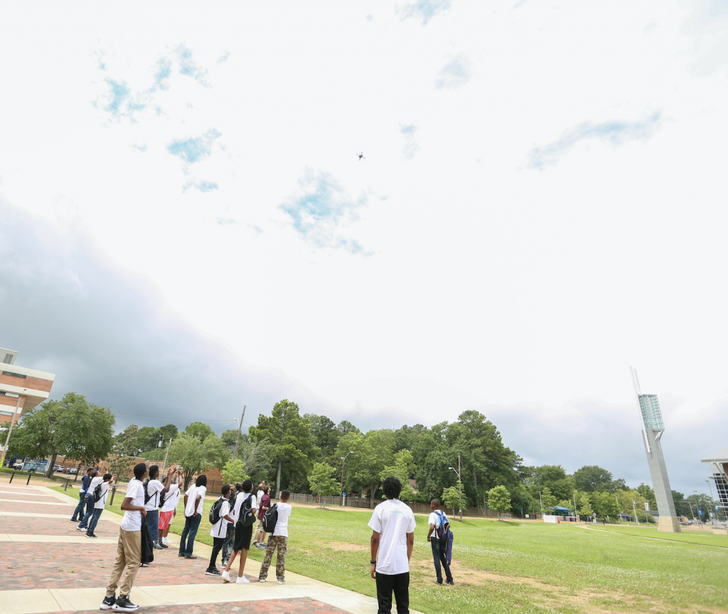 Students in the JSU Verizon Innovative Learning STEM Program watch in amazement as the drone soars to great heights before landing. (Photo by Kentrice S. Rush/JSU)