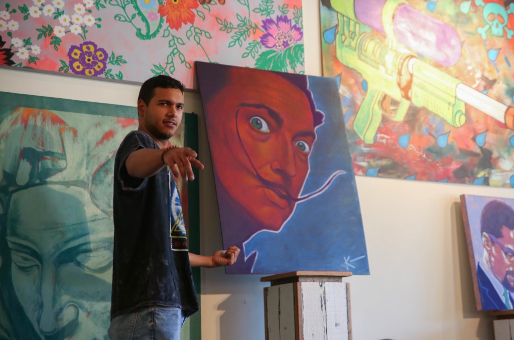 Pop-artist Kenan Mason, who received his bachelor's in graphic design from JSU in 2013, introduced students to the work of American artist Andy Warhol during his class. He told the students, "Pop-art depicts things from popular culture in colors and images that sort of pop off the page." (Photo by Kentrice S. Rush/JSU)