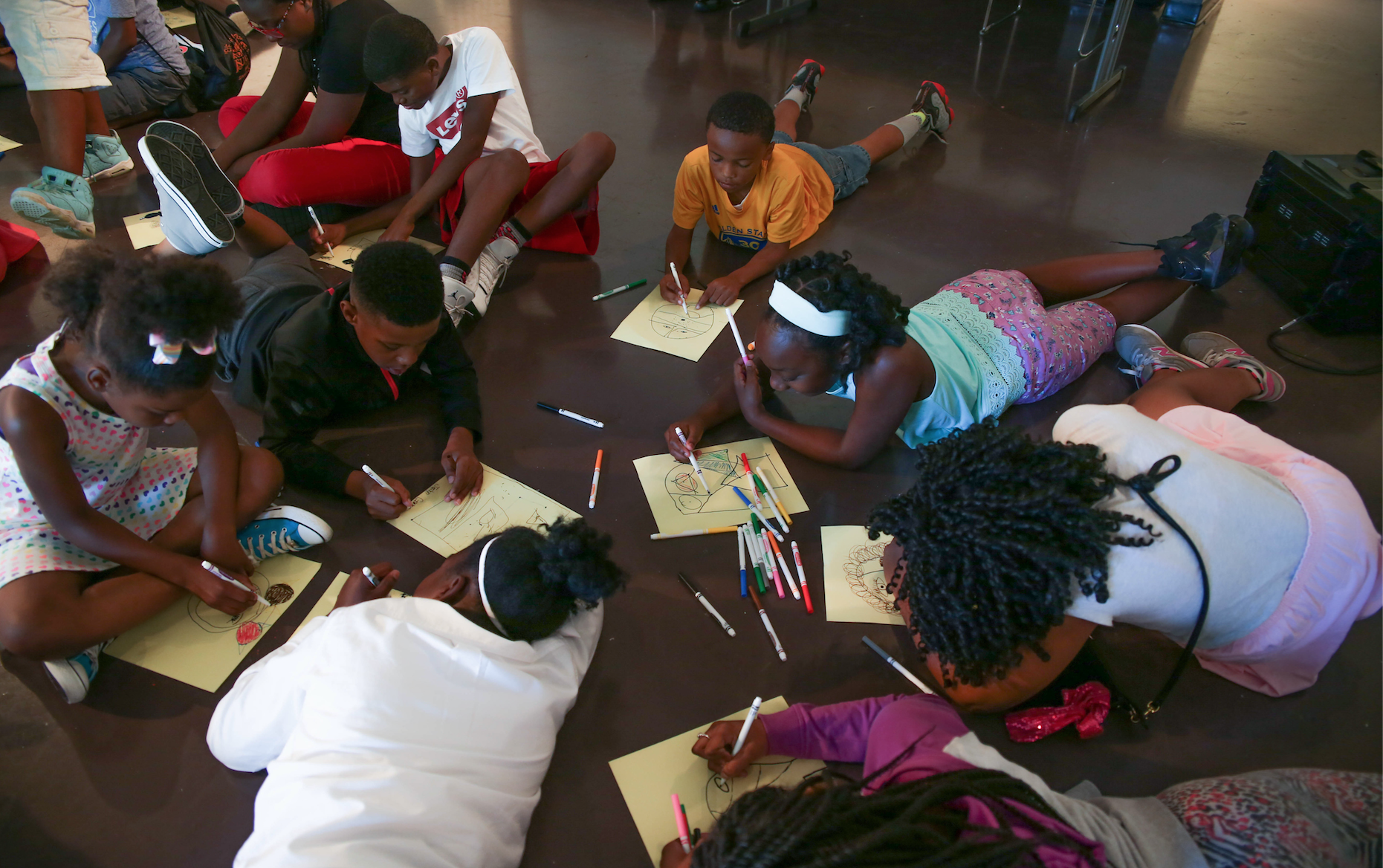 Students in various stages of picture making as they sprawl comfortably across the floor of JSU's Gallery1. (Photo by Kentrice S. Rush/JSU)