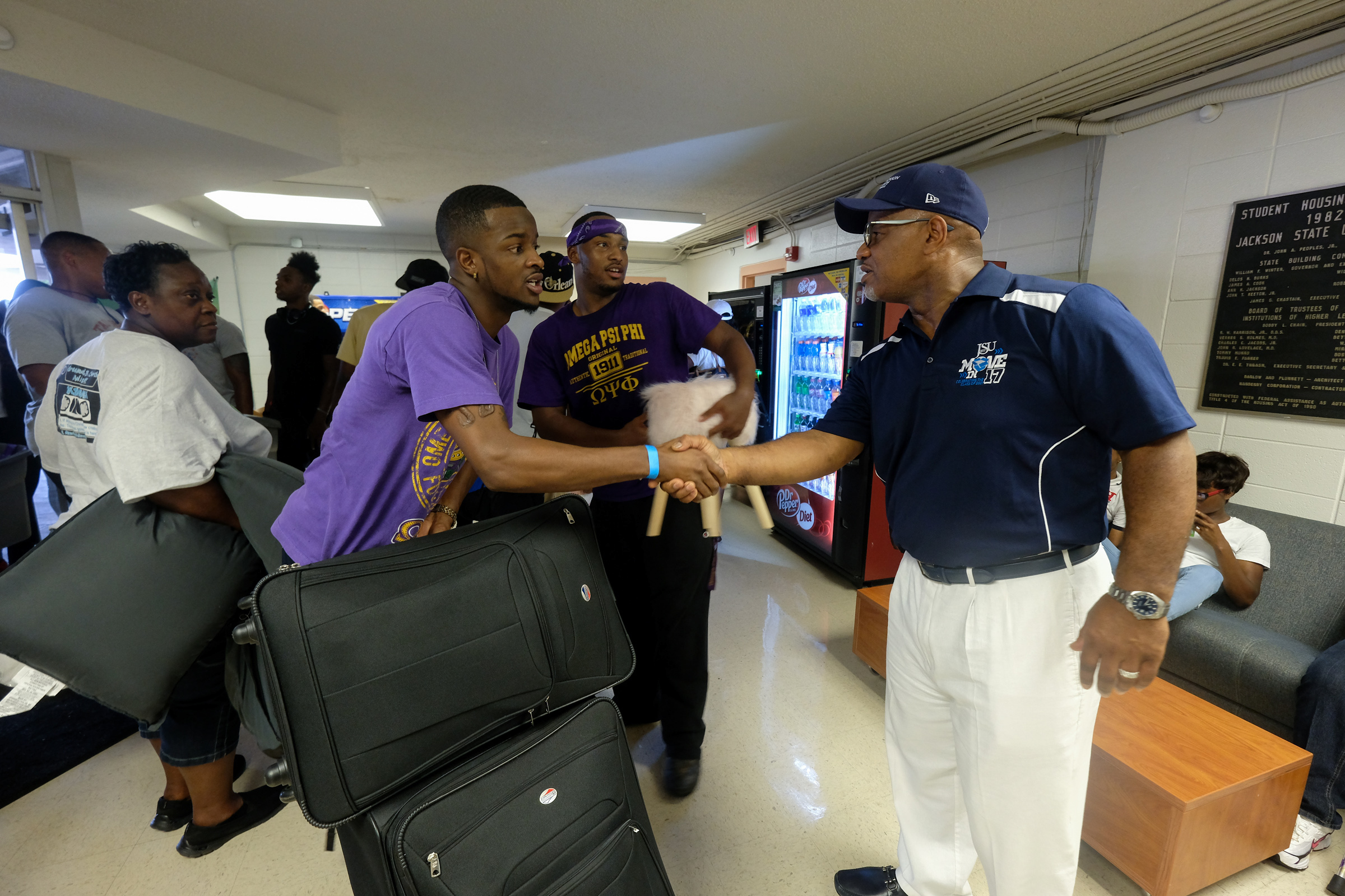 JSU President William B. Bynum, Jr., greets student-volunteer DaQuan Powell in the lobby of McAlister-Whiteside. Bynum believes that in order to lead, students must also know how to serve. (Photo by Charles A. Smith/JSU)