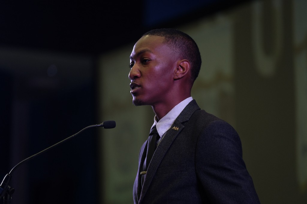 JSU senior Kyle Kidd-Buckner, president of the Campus Activities Board, introduces Bynum to the audience, describing the president as a leader focused on student achievement. (Photo by Charles A. Smith/JSU)