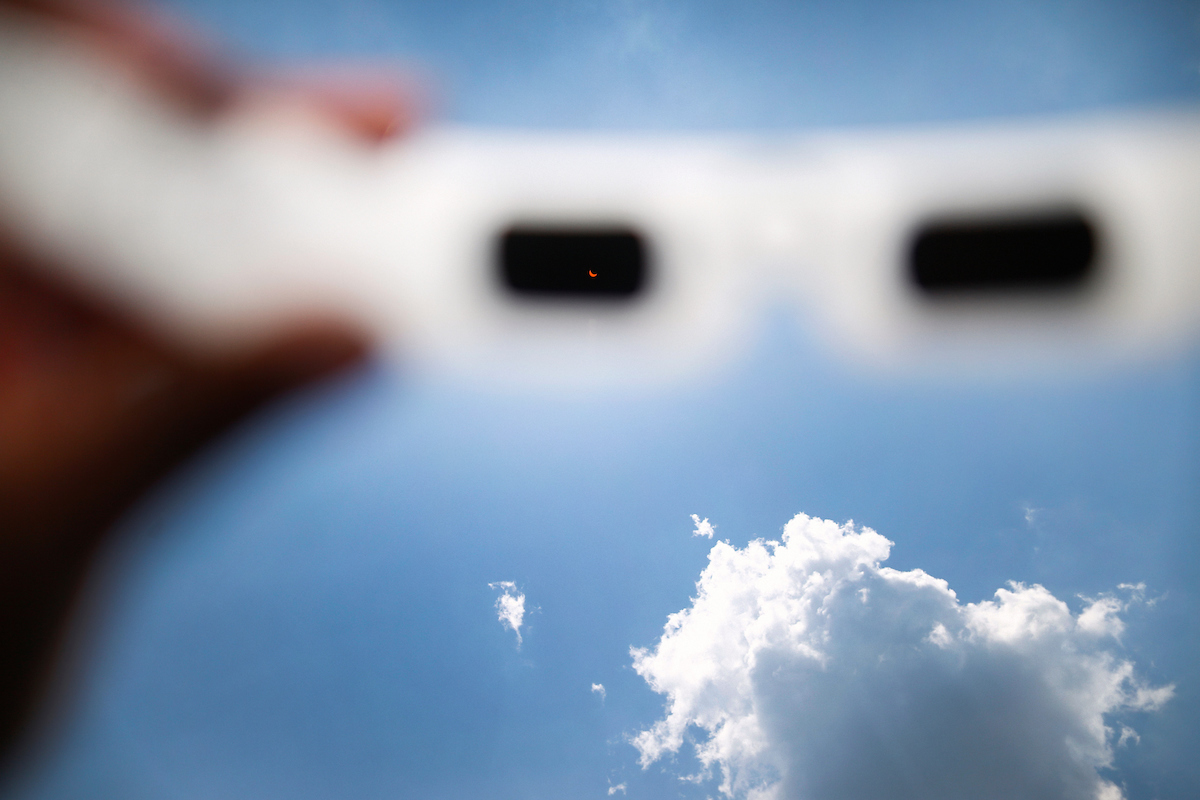 A pair of special solar eyeglasses captures Monday’s brief phenomenon in which the moon spectacularly blocked the sun during the first eclipse in the U.S. since 1979. (Photo by Charles A. Smith/JSU)