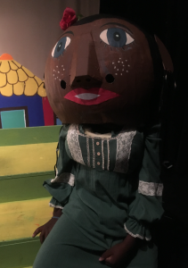 A student in full performance attire waits patiently for her entrance as a giant in the play "Jack and the Wonder Beans" waits patiently for the moment she will make an appearance. (Photo special to the JSU newsroom)