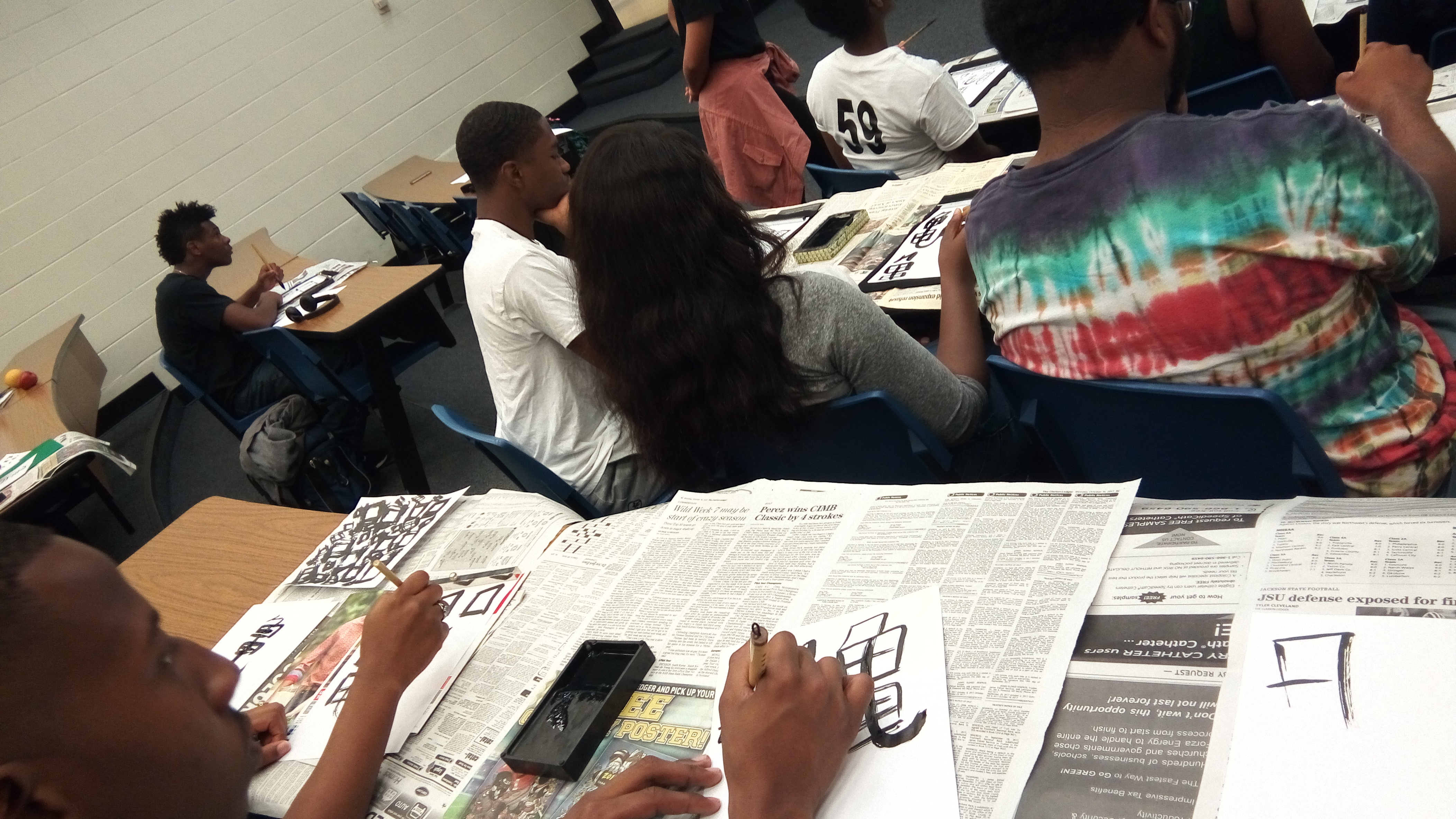 Students practice the Japanese art of Calligraphy during the University's "Japan Day."
