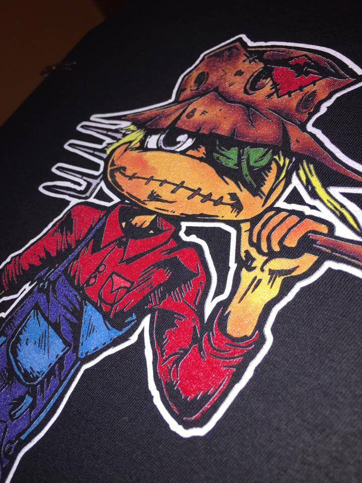Deeply Rooted’s most popular seller is a t-shirt called Planting Seeds of Knowledge which is centered around a scarecrow motif. Atkins explains that the scarecrow is protecting a garden that is planted with the seeds of what people strive or wish to become one day.