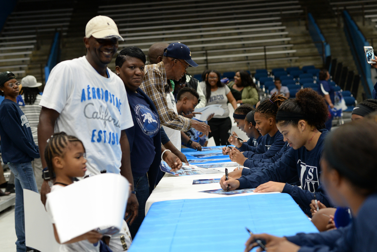 JSU’s women’s basketball members greet supporters during Basketball Madness, signing posters. (Photo by Darek Ashley/JSU)