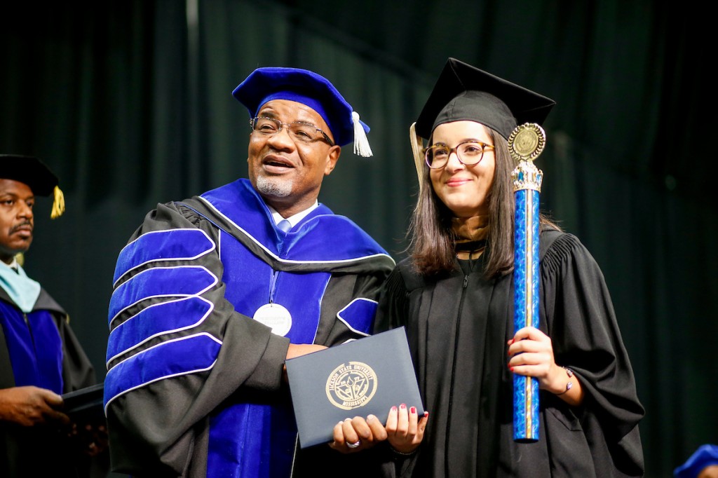 JSU President William B. Bynum Jr. congratulates JSU photography intern Anissa Hidouk. (Photo by Charles A. Smith/JSU)