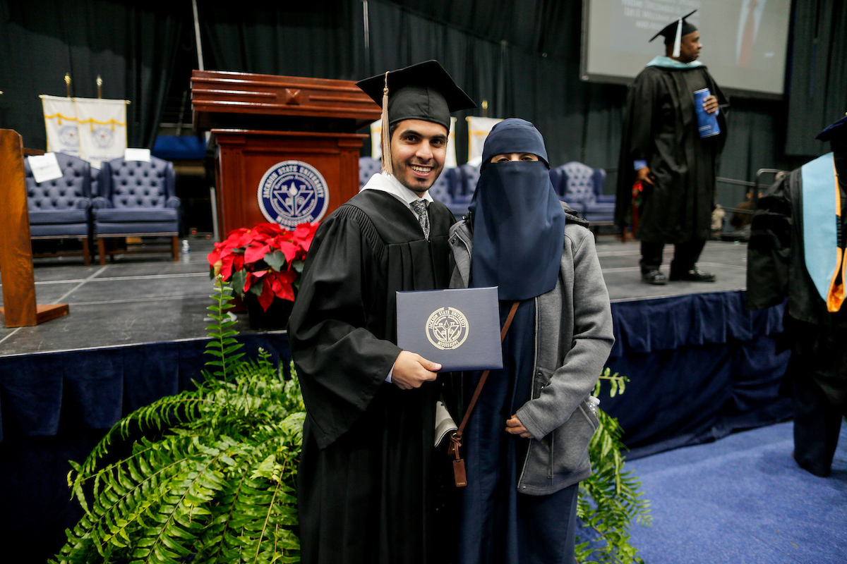 A proud, new JSU alum is congratulated by his wife. (Photo by Kentrice S. Rush/JSU)