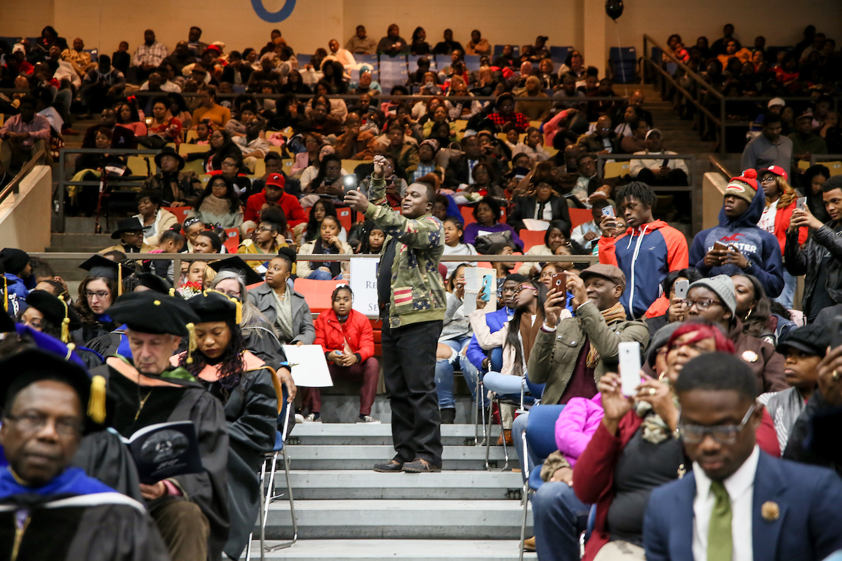 A guest positions herself in an ideal spot to capture a memorable moment. (Photo by Kentrice S. Rush/JSU)