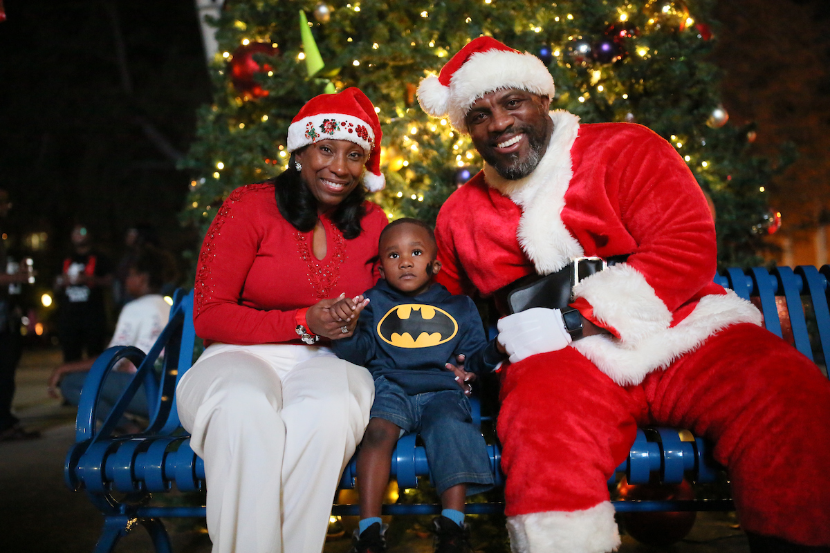 Santa (Coach Derek Scott, associate athletic director for Internal Operations) and Mrs. Claus (Dr. Debra Mays-Jackson, vice president and chief of staff) bring excitement to a little boy with a big wish during JSU’s annual “Holidays Under the Stars.” (Photo by Aron Smith/JSU)