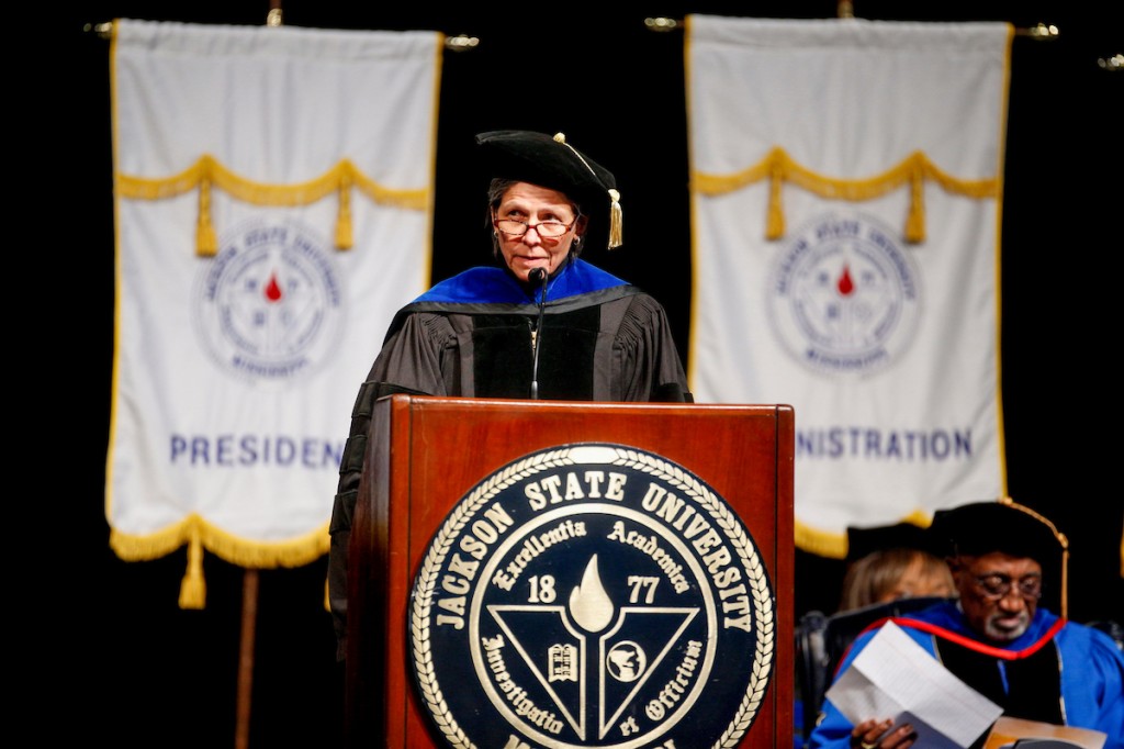 Dr. Darcie Bishop, associate dean of the Division of Graduate Studies, guides the ceremony.