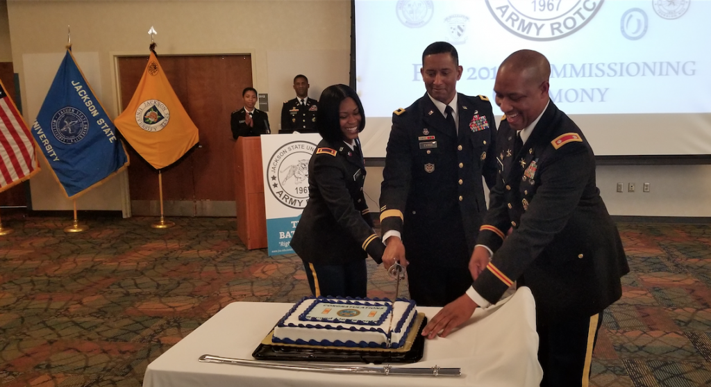 Lt. Col. Dexter M. Brookins, chair and professor of JSU’s Military Science, assists with one of the sweetest parts of the ceremony. He’s joined by Tashe’Wa N. Hill and Evans.