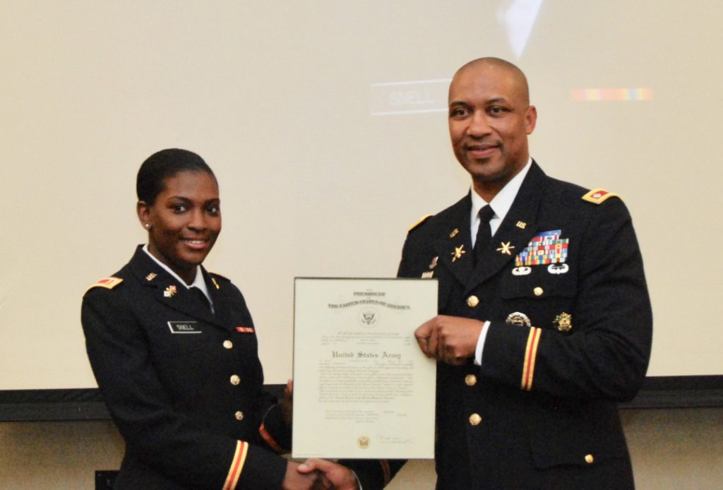 Brookins presents an official declaration to 2nd Lt. Eva N. Snell from the U.S. Army.