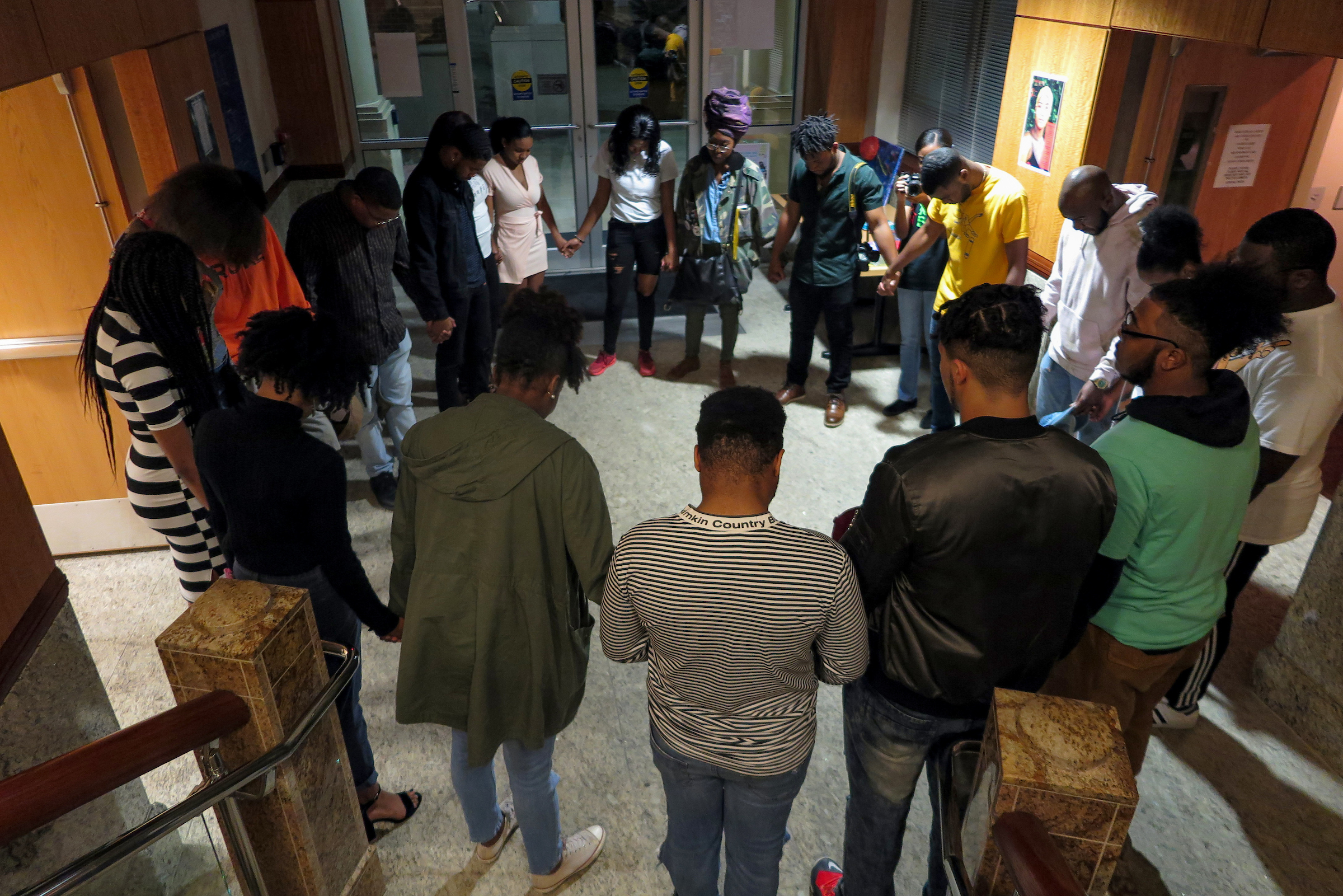 The 25-member creative arts collective OutSpoken gather together in prayer before the New Member Showcase in Johnson Hall on Feb. 20. (Photo by Rachel James-Terry/JSU)