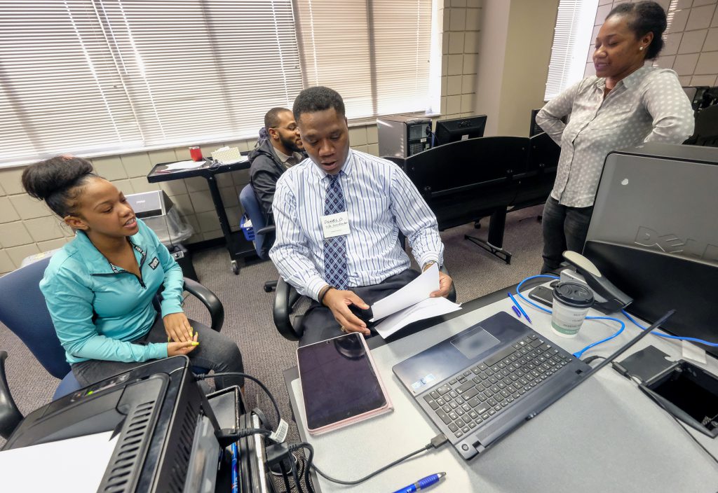 Accounting instructor Donald McWilliams assists clients with free income tax preparation.