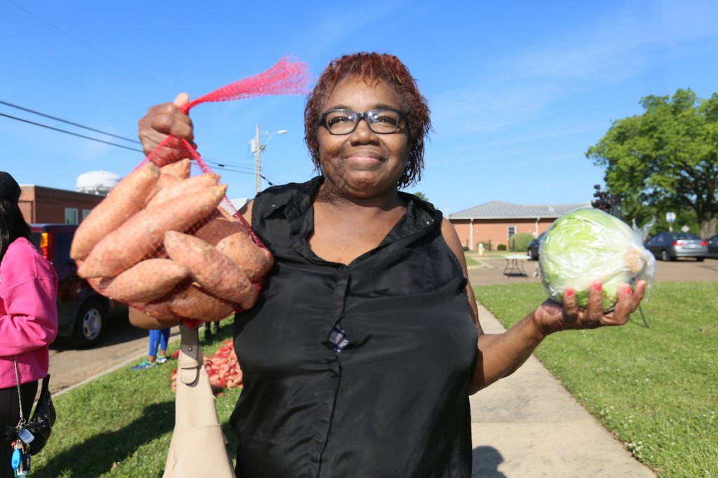 Some community members gleefully walked up to get their share of the produce. (Photo by Charles A. Smith/JSU)