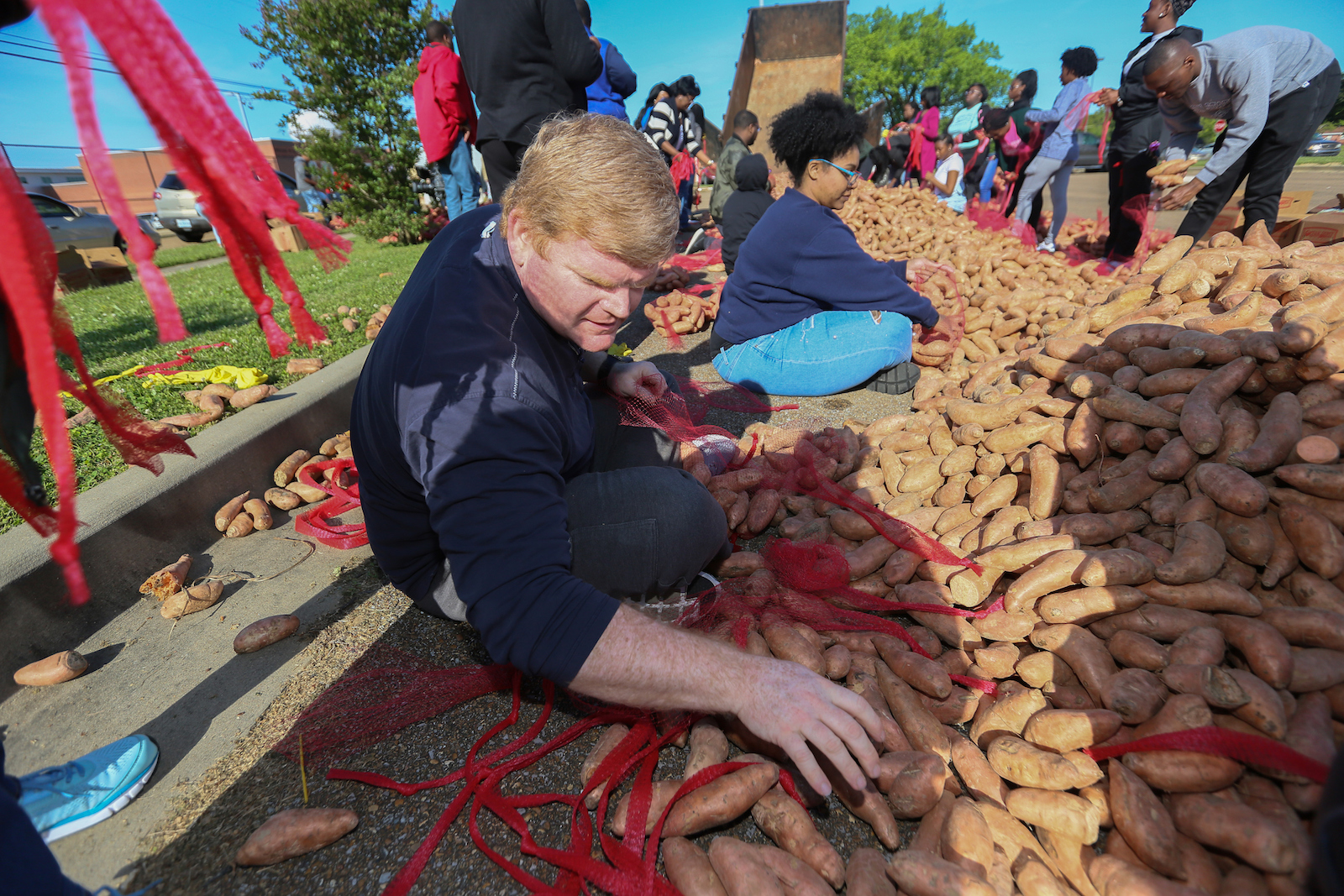 Dozens of volunteers meticulously sack the sweet potatoes that have become a hot commodity with the community during JSU’s Crop Drop. (Photo by Charles A. Smith/JSU)
