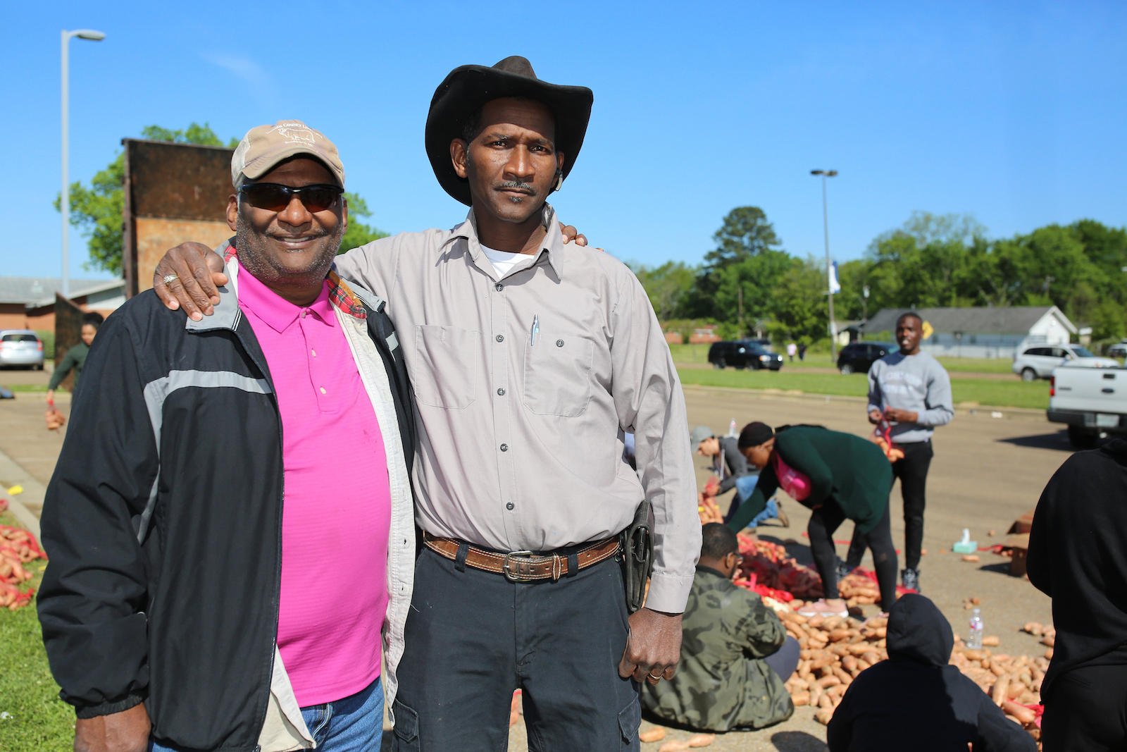Simon Taylor of Taylor Construction of Mississippi Inc. of Brandon, right, traveled to Vardaman to help transport nearly 20,000 pounds of sweet potatoes in his trailer truck. “Helping out was a no-brainer when I learned this was for the community,” Taylor said. He’s assisted by one his supportive friends. (Photo by Charles A. Smith/JSU)