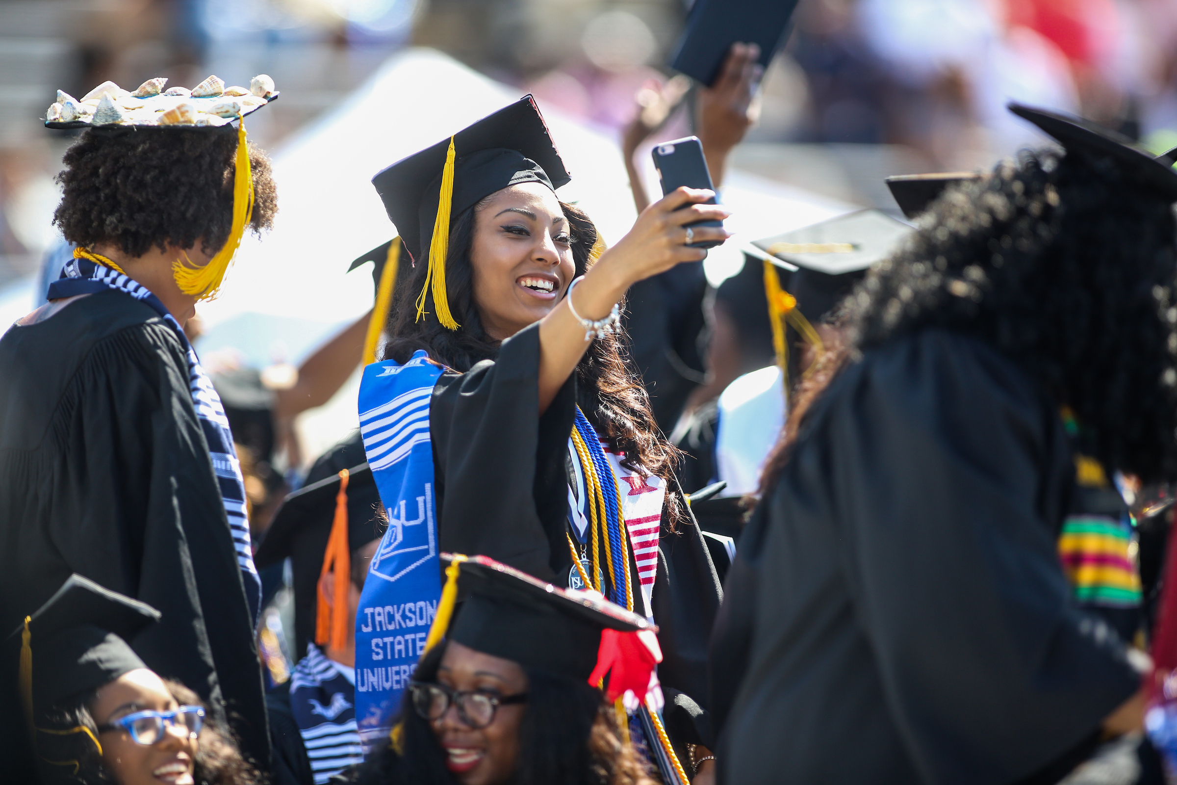A graduate makes sure her selfie-game is on point. (JSU)