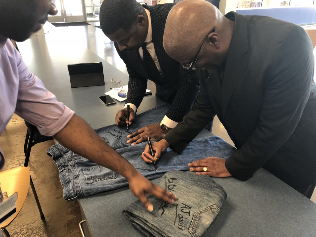 During the recent event for Denim Day, which highlights sexual assault awareness, Horton encouraged students, faculty and staff to sign jeans to show their support of the campaign. Dr. Steven Smith, left, associate dean of JSU's Enrollment Management and director of Admissions and Recruitment, pens his name to the garment. Warren Johnson, associate, vice president and dean of Enrollment Management, joins him in a show of solidarity. (Photo by L.A. Warren/JSU)