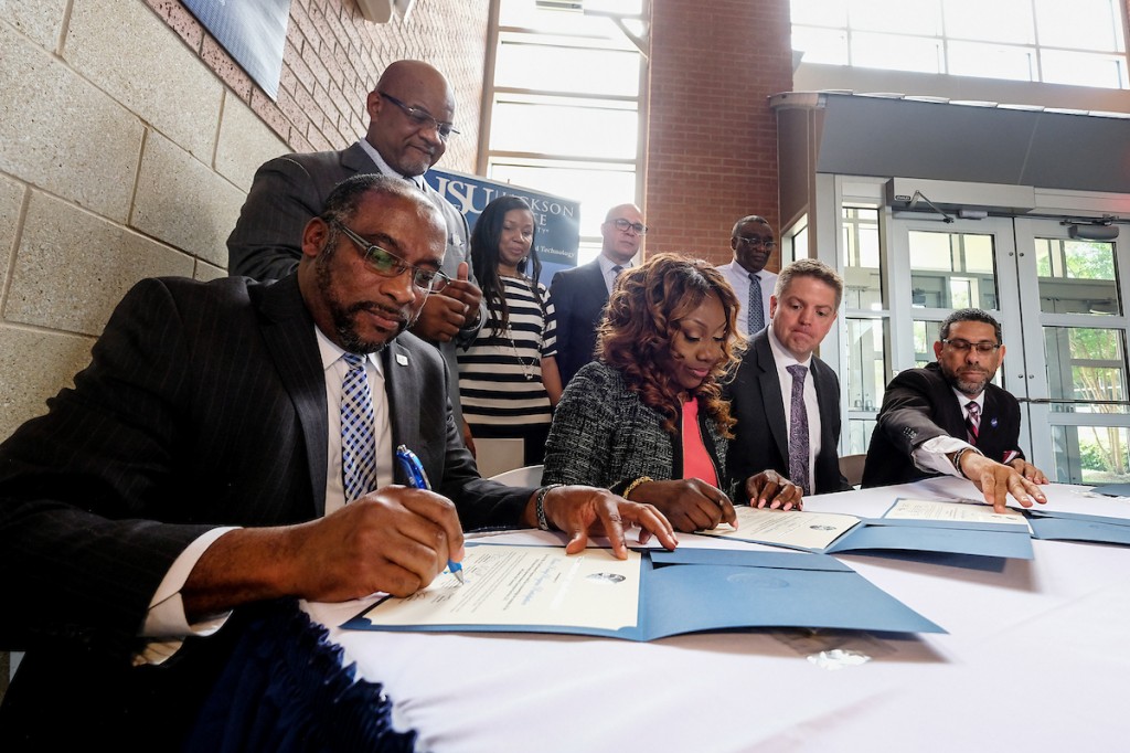 Dr. Joseph A. Whittaker signs a deal that eventually will position JSU as a prime federal contractor. The urban institution will be part of a protégé program that provides training from its mentor, Enterprise Services LLC. (Photo by Charles A. Smith/JSU)