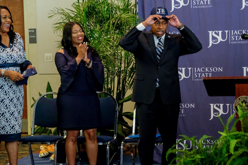 With proud support from wife Danielle, Robinson shows his Tiger spirit by donning a JSU cap. (Photo by Charles A. Smith/JSU)