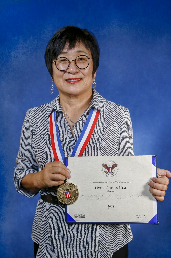 Kim poses with the medal and certificate she received from the White House for her impressive volunteer efforts. (Photo by Charles A. Smith/JSU)