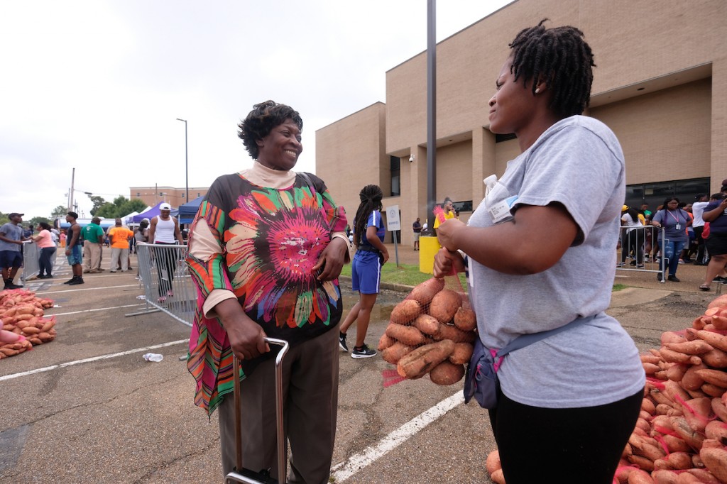 A walk-up customer express delight as a volunteer assists. (Photo by Charles A. Smith/JSU)