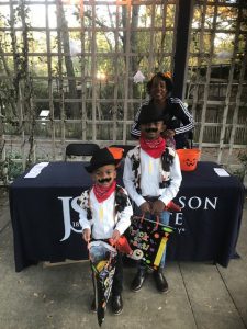 Carroll Frazier, administrative assistant/community outreach specialist for CUBD, provides treats to a couple of cowboys during Boo at the Zoo.