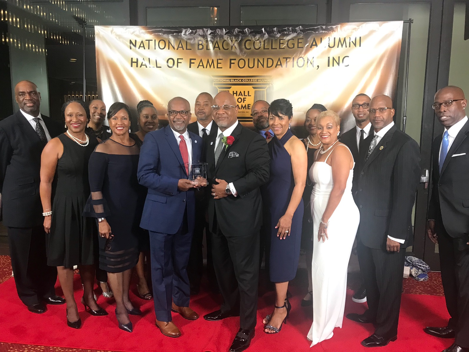 Hall of Fame honoree Dowell Taylor, director of bands, is congratulated by JSU President William B. Bynum Jr. and first lady Deborah Bynum during a recognition in Atlanta. Others celebrants include employees and alumni of Jackson State University.