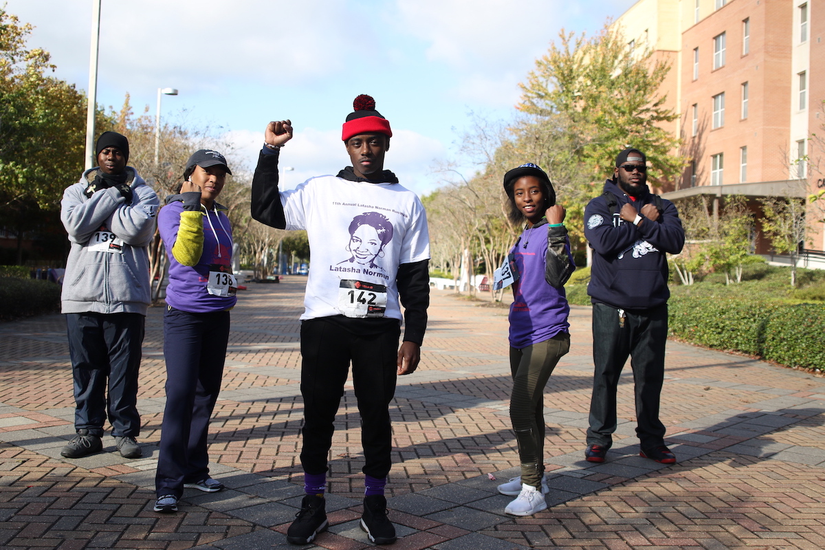Blue and White Flash staffers join in bringing awareness to domestic violence and abuse. They are Aaron Walker, left, a senior from Jackson; Deja Davis, a junior from Atlanta; Clement Gibson, a senior from Minneapolis, Minnesota; Shay Humphrey, a senior from Marks; and Darrius Barran, a junior from Chicago. (Photo by Aron Smith/JSU)