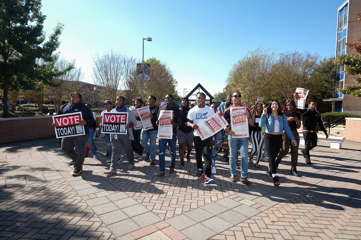 JSU’s SGA president LaCurtis Powell and SGA vice president Jordan Jefferson, center, lead throngs of voters to the JSU Student Center to cast their ballots for midterm candidates – locally and statewide. Tuesday’s “March to the Poll Hotspot” is credited with catapulting JSU’s Precinct 49 to a whopping 194 percent increase in voting since the last major balloting there. (Photo by Charles A. Smith/JSU)