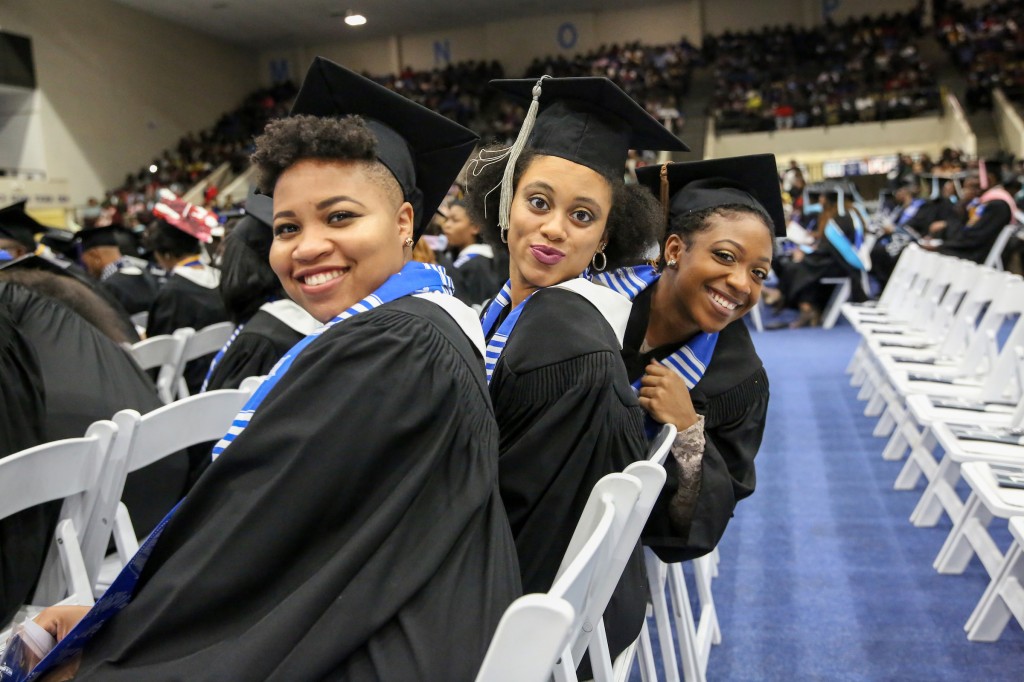 Graduates pose while waiting to receive their degrees. ( Aron Smith/University Communications)