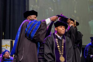 Dr. Herman Felton, Jr., president of Wiley College is hooded during the fall 2018 commencement exercise. (Charles A. Smith/University Communications)