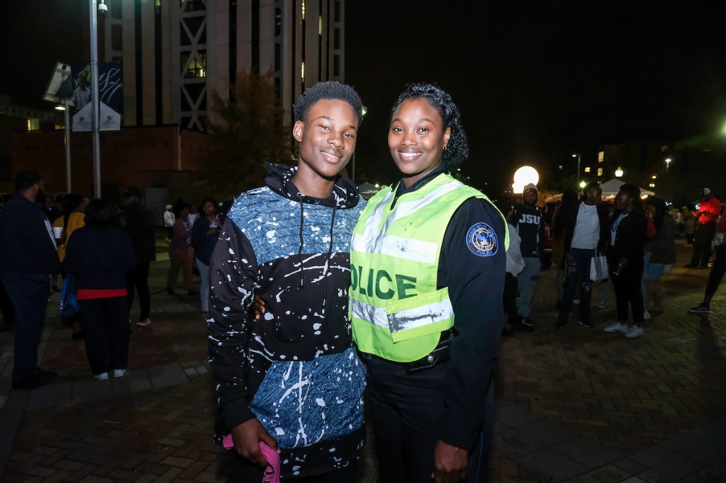 : JSU Public Safety officer Salisha Jordan and her 14-year-old son Adonis experience their first Holidays Under the Stars. Adonis was so captivated by the entertainment that he said, “This is an event I would recommend to everyone I meet.” His mother described it as a nice and sweet occasion for the students at JSU and the community.” They both will spend the holiday in Atlanta and North Carolina. (Photo by Charles A. Smith/JSU)