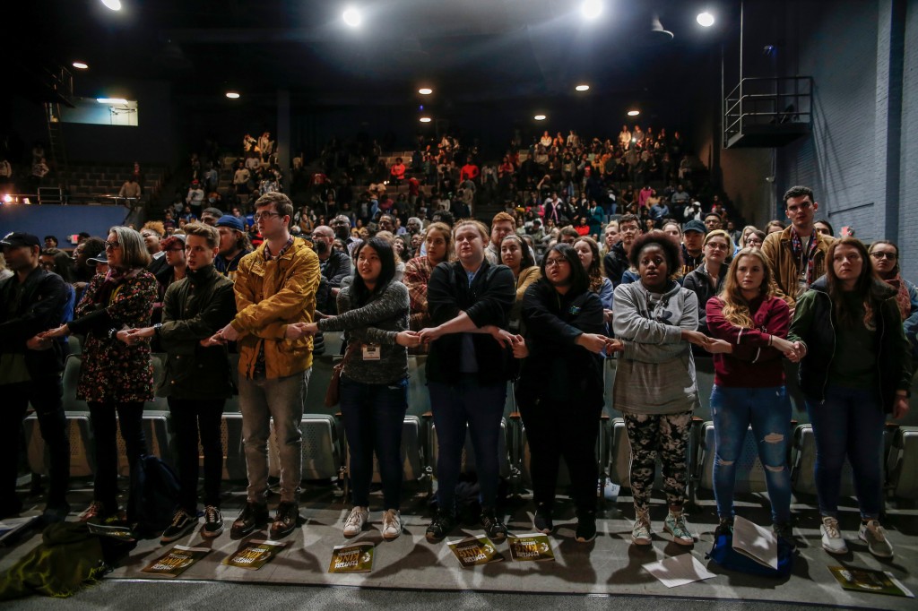 Students lock hands in tribute to the life of Martin Luther King Jr., towards the end of the MLK celebration program at JSU. (Photo by Charles A. Smith/JSU)