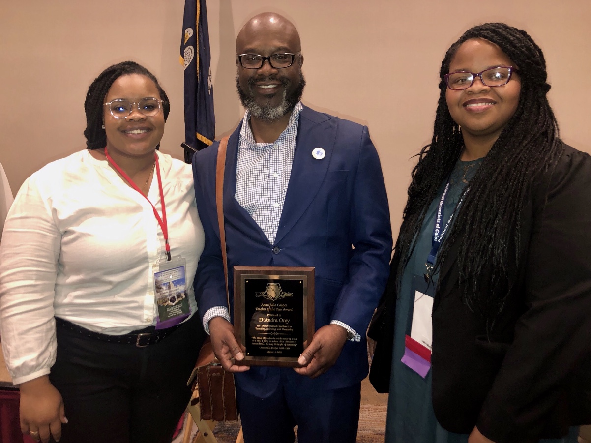 Dr. D'Andra Orey, professor of political science, poses with students after accepting his Anna Julia Cooper Teacher of the Year Award in Baton Rouge, LA.