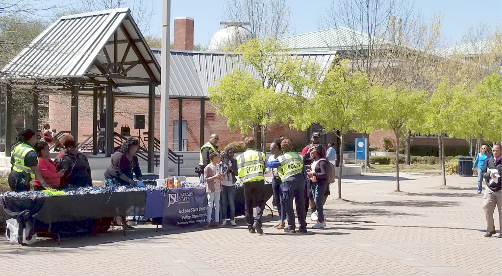 Officers engage with students on the plaza to provide safety tips.