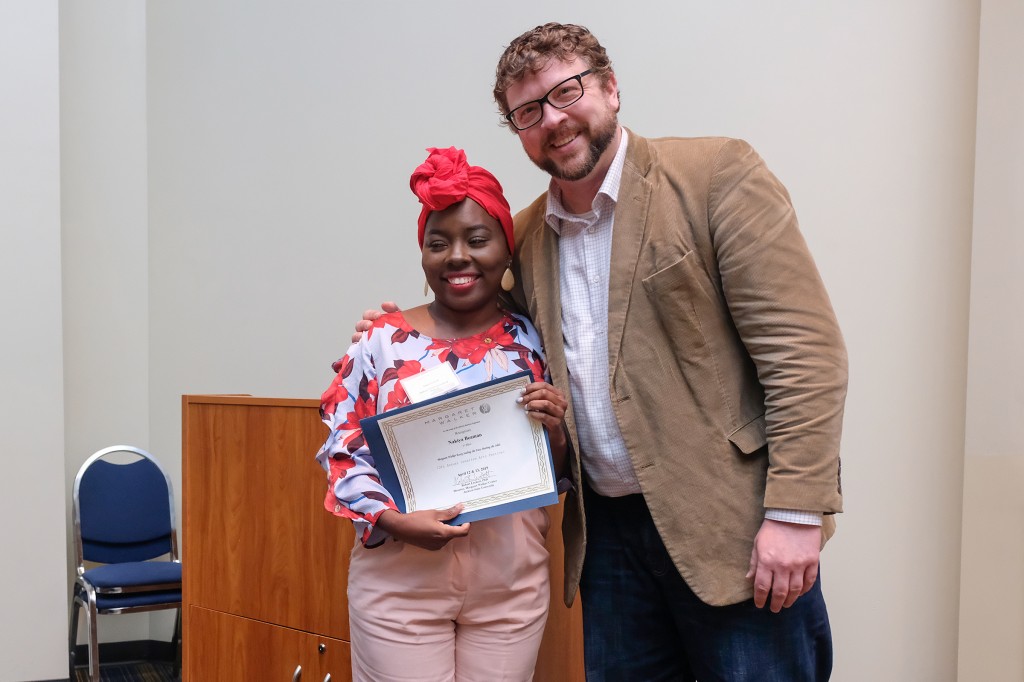 Nakiya Beaman, a graduate student, receives the $1,000 first place prize for her essay “Sealing the Fate and Beating the Odds.” (Photo by Charles A. Smith/JSU)