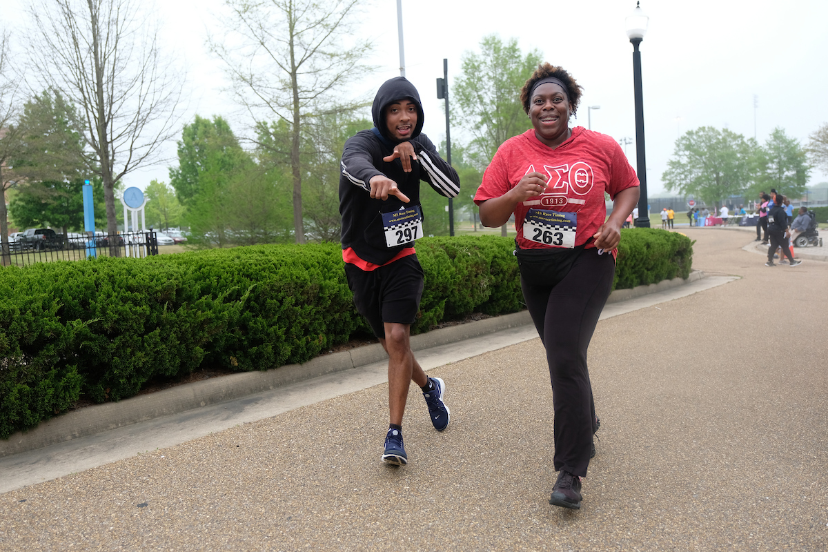 Striding alongside one another, two runners make the course look easy and fun. (Photo by Aron Smith/JSU)