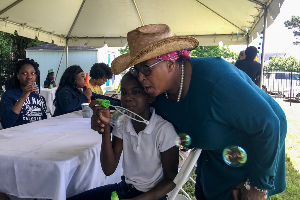 Feeling a little bubbly, a patron gets in on the fun with one of Blackburn’s students. (Photo by Charles A. Smith/JSU)