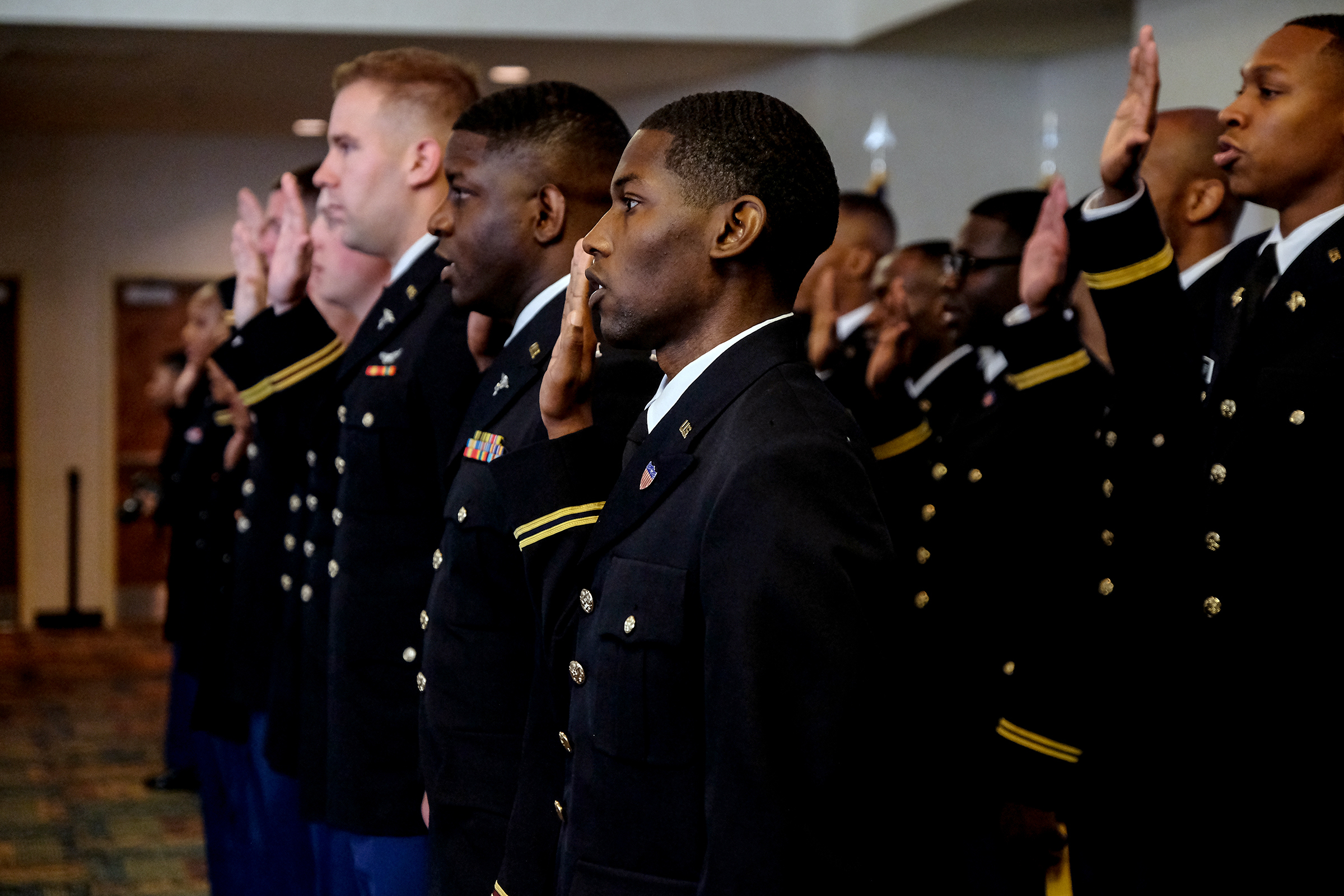 Seventeen cadets newly commissioned as 2nd lieutenants take the oath to uphold and defend the Constitution of the United States. (Photo by Charles A. Smith/JSU)