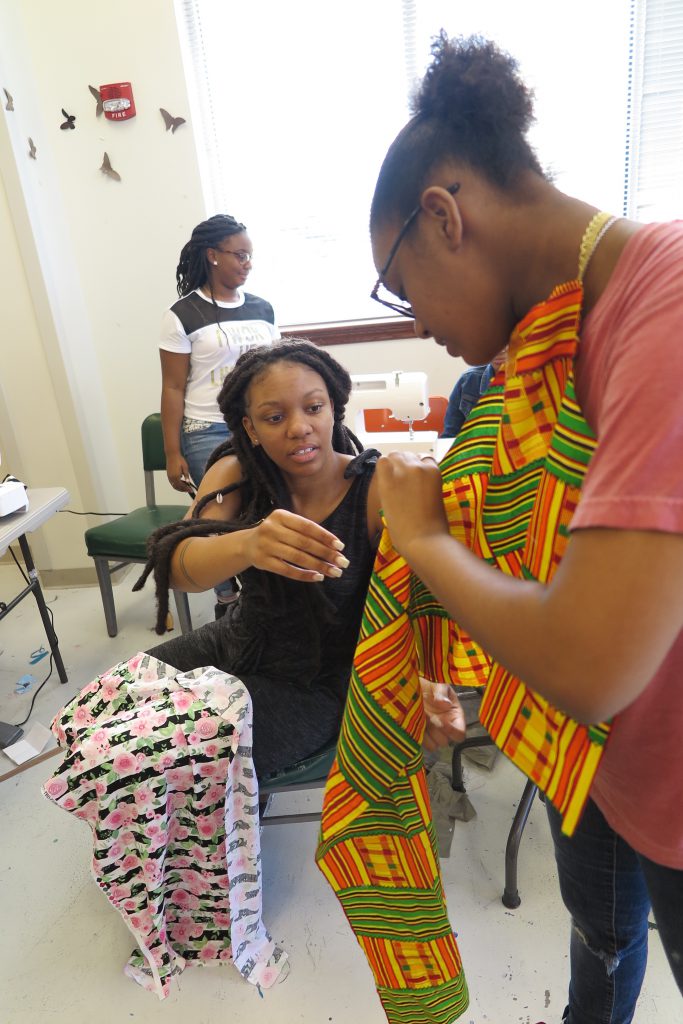Kristen Martin, director of the JSU Summer Art Institute Sewing Camp, helps camper Kennedy Anderson with a sewing technique. (Photo by Rachel James-Terry/JSU)