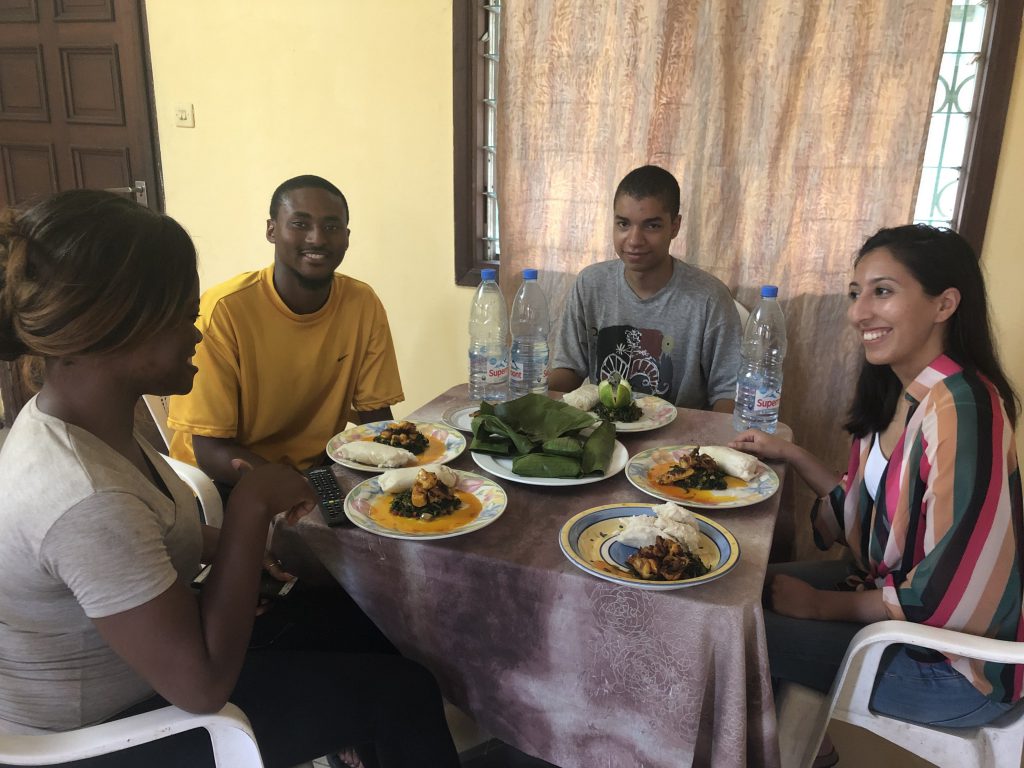 Markus Brooks, a criminal justice major at JSU, and students from the East coast, indulge in local cuisine during their stay in Cameroon,where they witnessed the Cameroon justice system in action, toured the sites and helped residents learn more about the medical center in the ares. (Photo special to JSU)