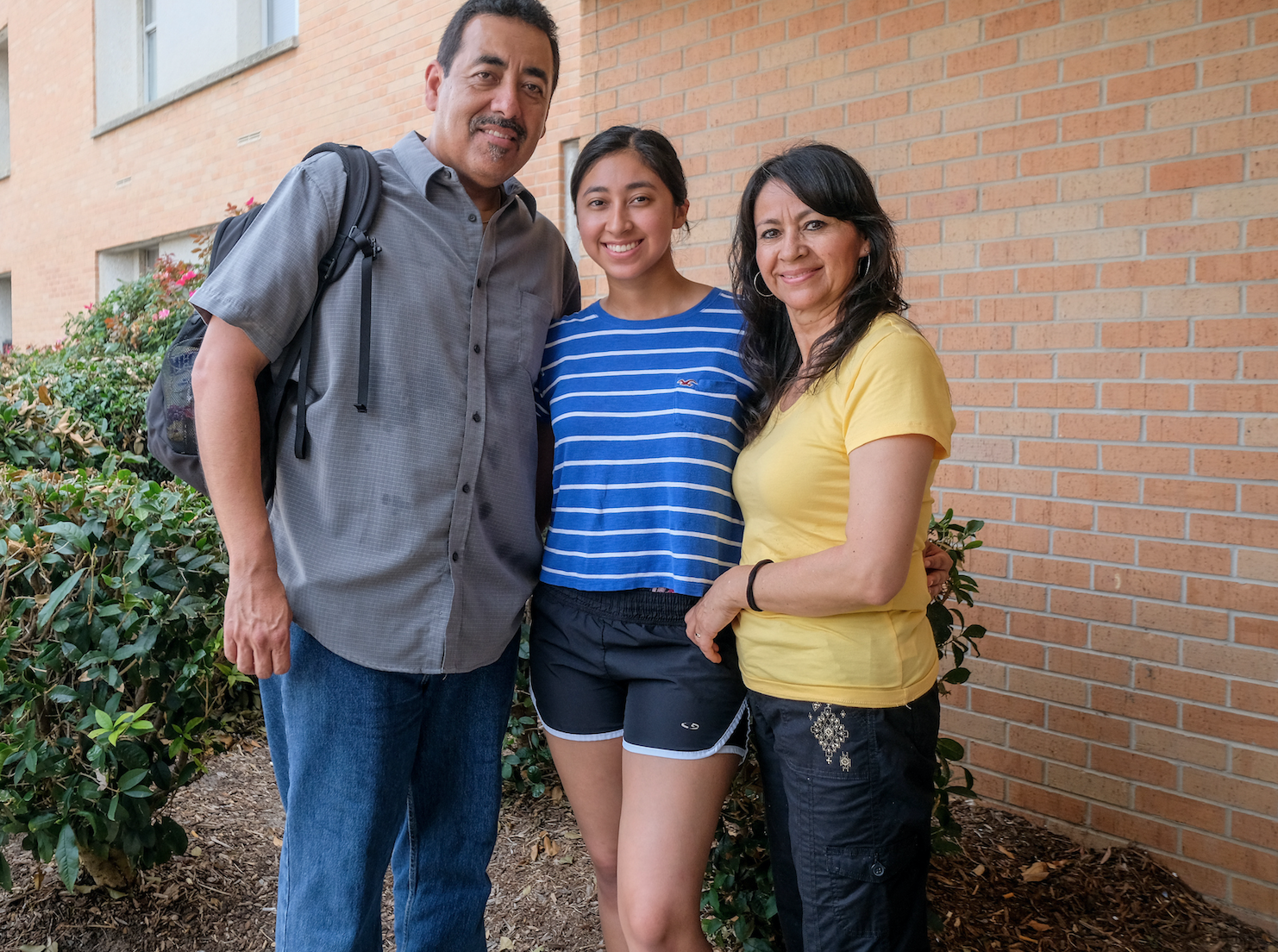 "If it was up to my parents, I would be attending college close to my home but they allowed me to make my own decision," says Monica Serrano. "People who live in California have told me that I should come here so I know I'm in a good place." Serrano is pictured with her mother and father. (Photo by Charles A. Smith/JSU)
