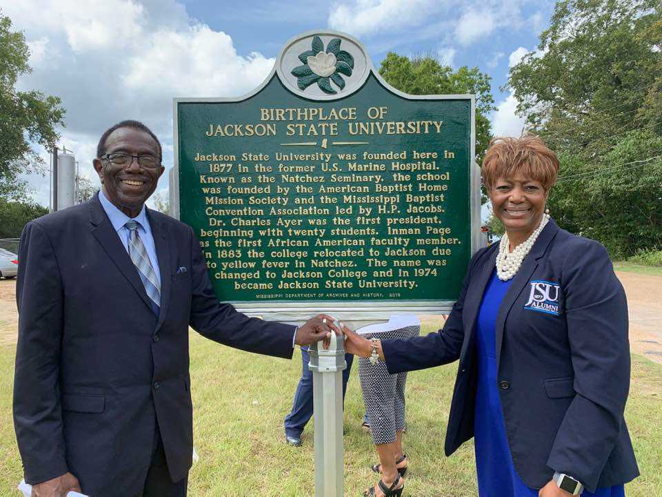 Alumnus and JSU professor Dr. Hilliard Lackey poses beside the marker with JSUNAA President, Dr. Earlexia Norwood.