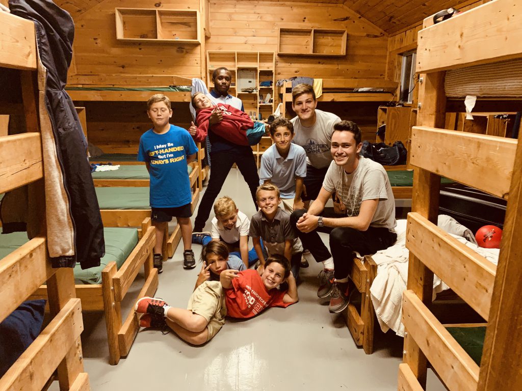 Jabaris Jefferson, a student at JSU, hangs out with his rambunctious band of campers inside their cozy digs at Iroquois Springs Summer Camp in Rockhill, New York. (Photo special to JSU)
