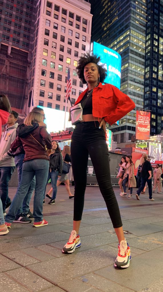 Olivia Howard stands in Times Square after walking in New York Fashion Week. She describes her experience as "surreal" and says "it was a dream come true."