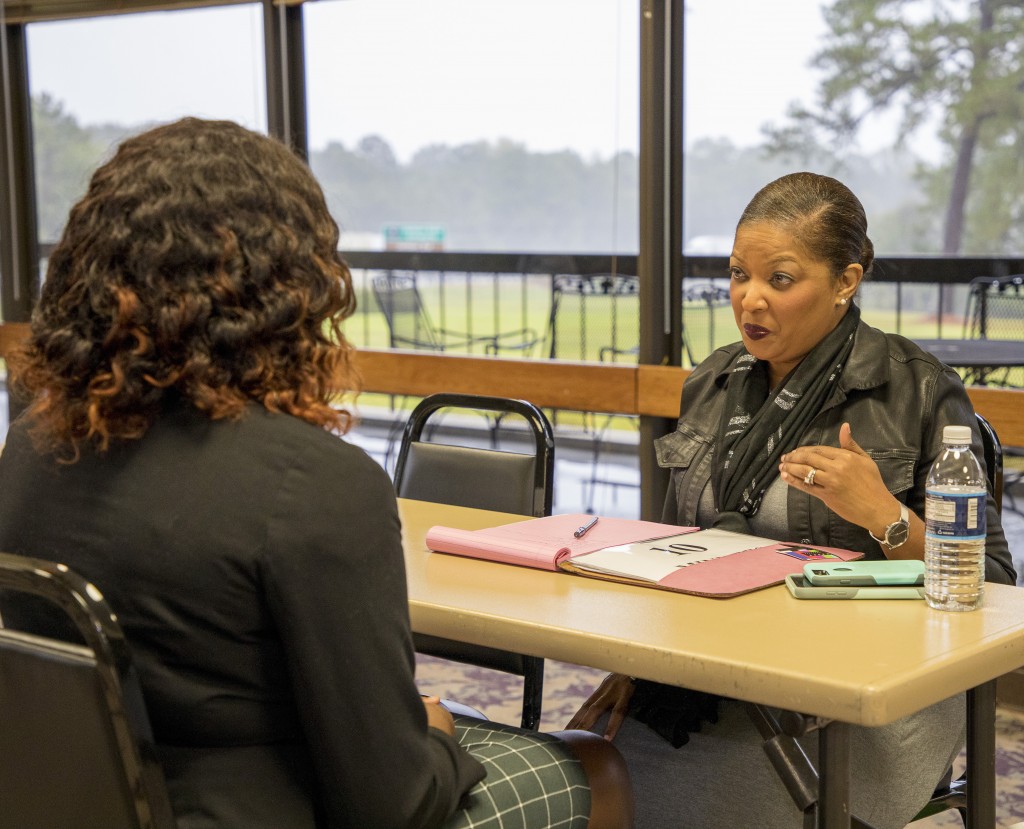 Galean Stewart, news director at WDAM in Hattiesburg, interviews a student who has questions about becoming a producer. (Photo by Don Spann)