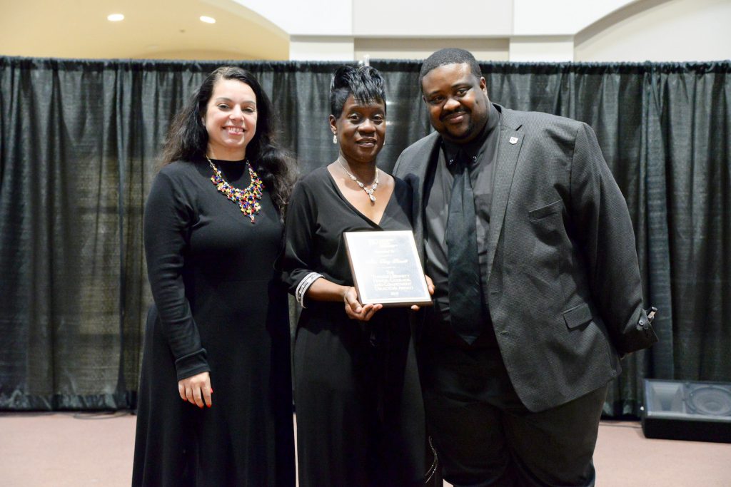 Bennett is congratulated by Heather A. Wilcox, director of JSU’s Center for University-Based Development, and her colleague Thompson. (Photo by Darek Ashley/JSU)